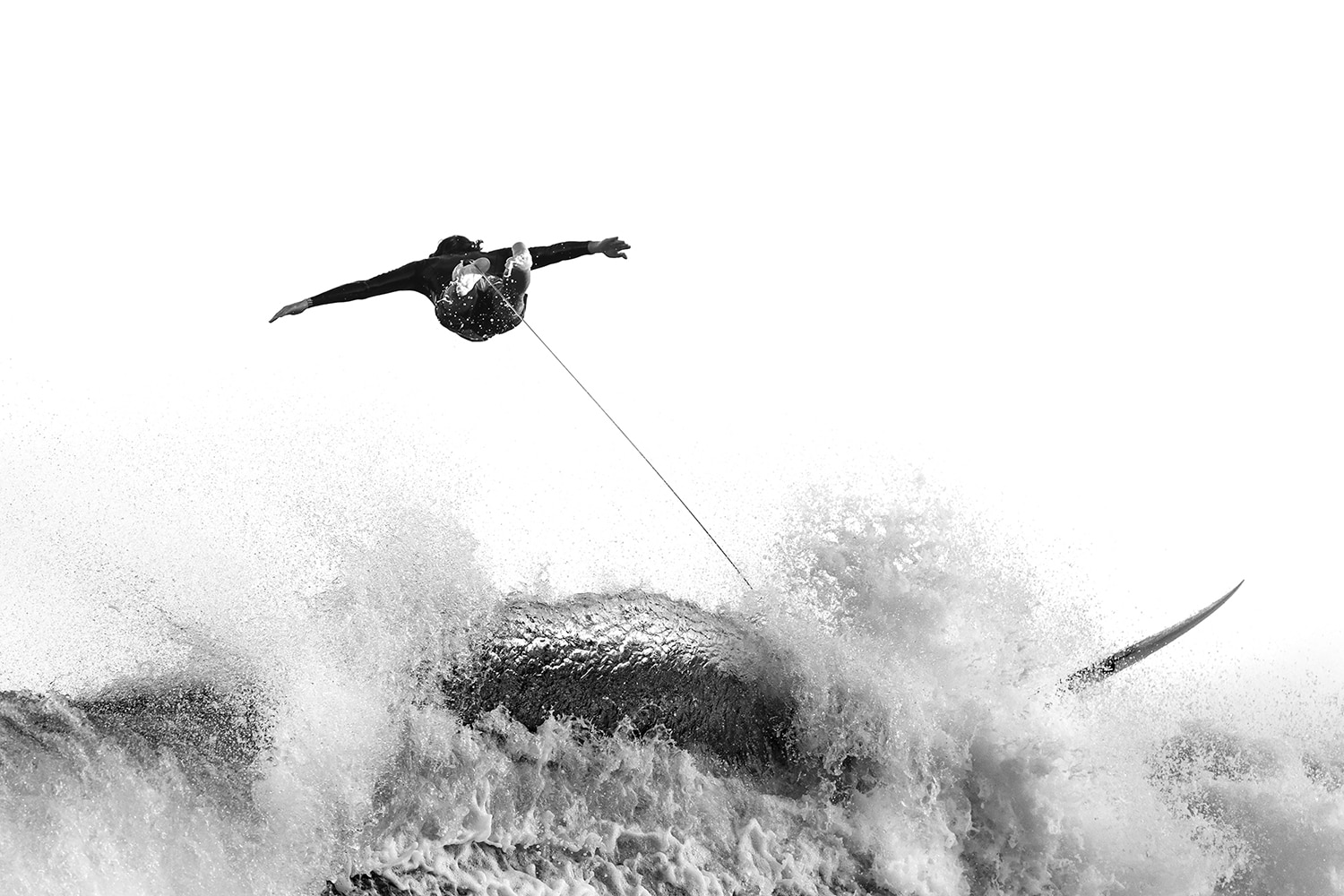 Award-winning fine art ocean print of a surfer soaring above a wave in Tamarama, black and white – "The Hunting Eagle"