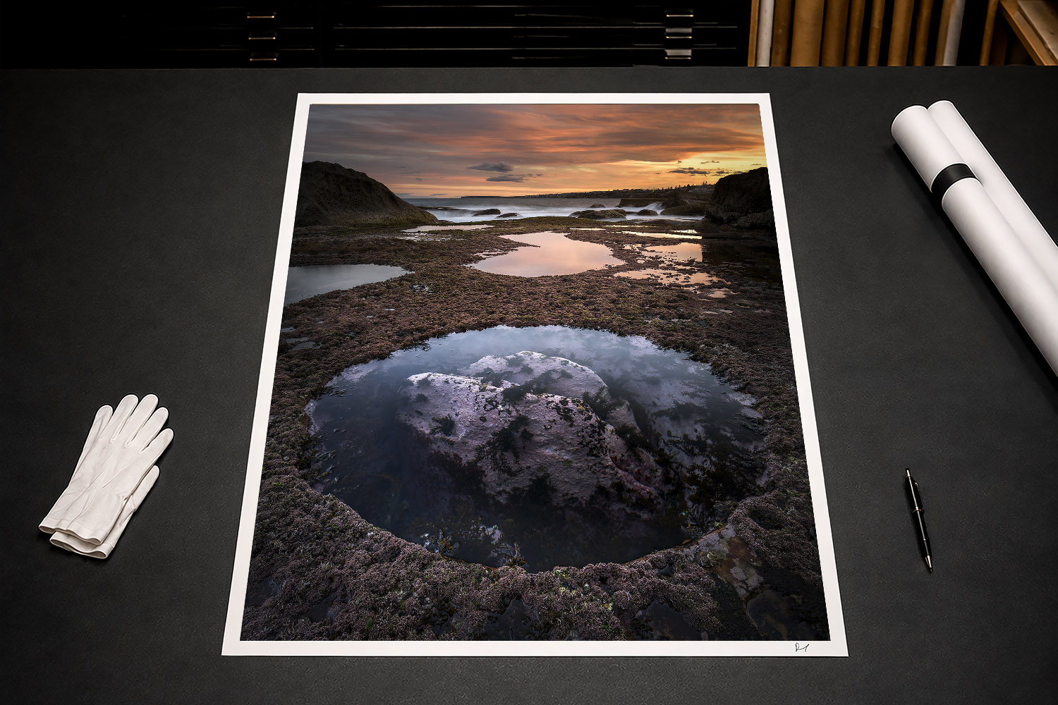 Fine art print featuring a reflective rock pool and dramatic sunset at Bondi Beach in Sydney, Australia.