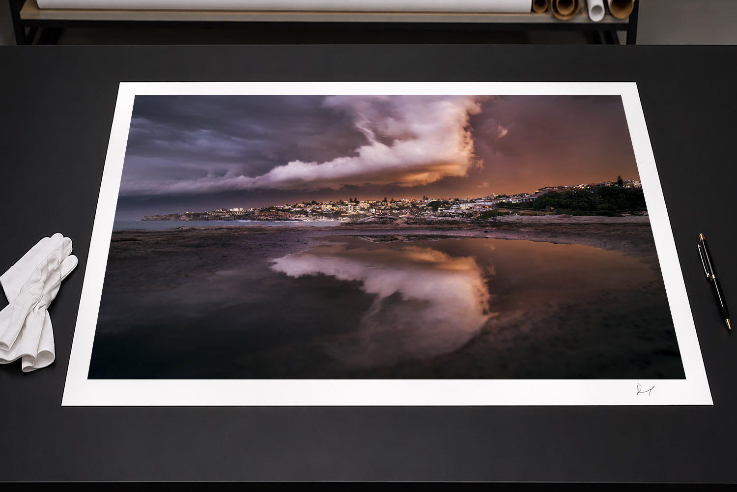 Fine art print of a dramatic storm sunset with fiery clouds reflected in rock pools at Tamarama Beach, Sydney.