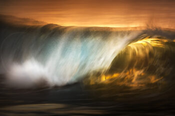 Golden sunrise illuminating a breaking ocean wave at Bronte Beach, Sydney, in fine art seascape photography