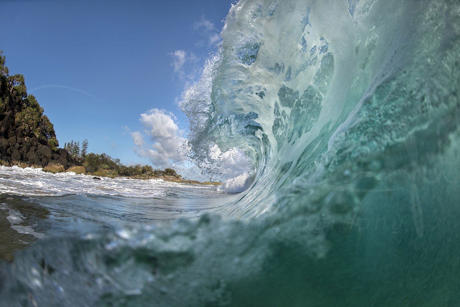 Turquoise barrel wave breaking beside the rocky shoreline at Snapper Rocks, Gold Coast, Australia, fine art ocean photography