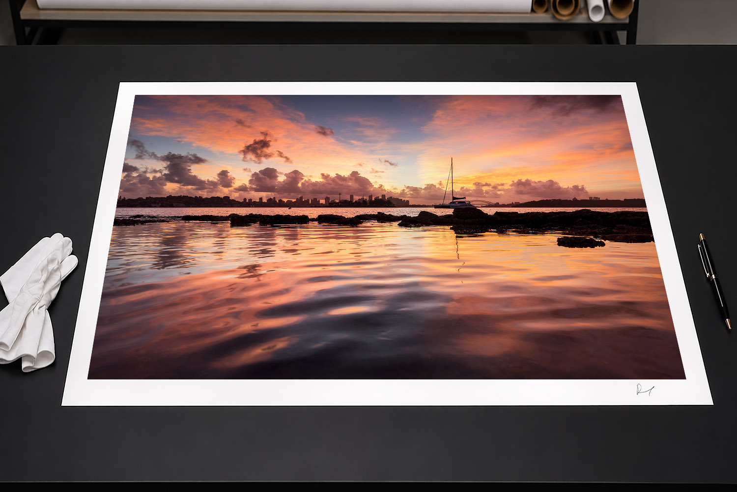 Fine art print of a vibrant Milk Beach sunset with a sailboat, Sydney skyline and glowing reflections across the harbour.