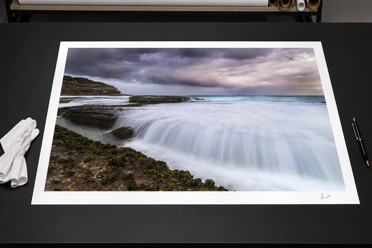 Fine art print of stormy sunset at Tamarama Beach, Sydney, with waves flowing over the rocky shoreline.