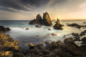 Camel Rock at sunset near Bermagui, NSW, with rugged sea stacks and silky ocean water, fine art seascape photography.