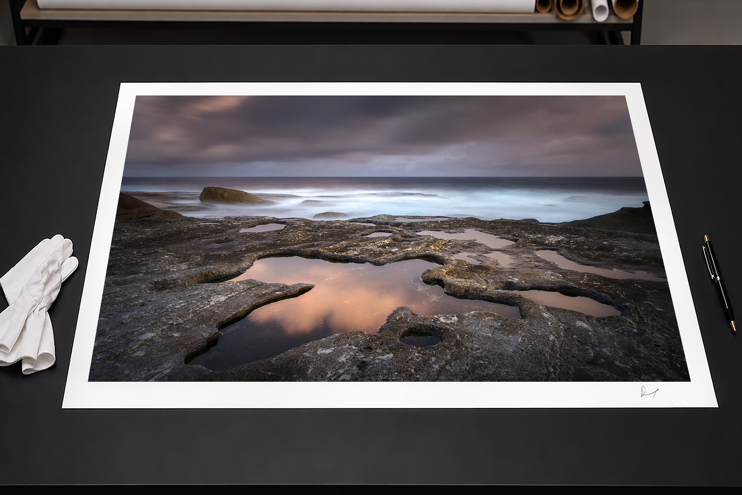 Fine art print of a Bondi Beach sunset with rocky tidal pools and pink cloud reflections, Sydney, Australia.