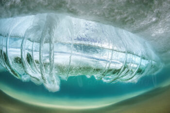 Underwater wave vortex with flowing curtains of water above a sandy seabed at Seal Rocks, New South Wales, Australia