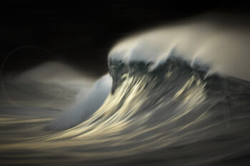 Breaking ocean wave glowing in golden sunrise light at Bronte Beach, Sydney, in fine art seascape photography.