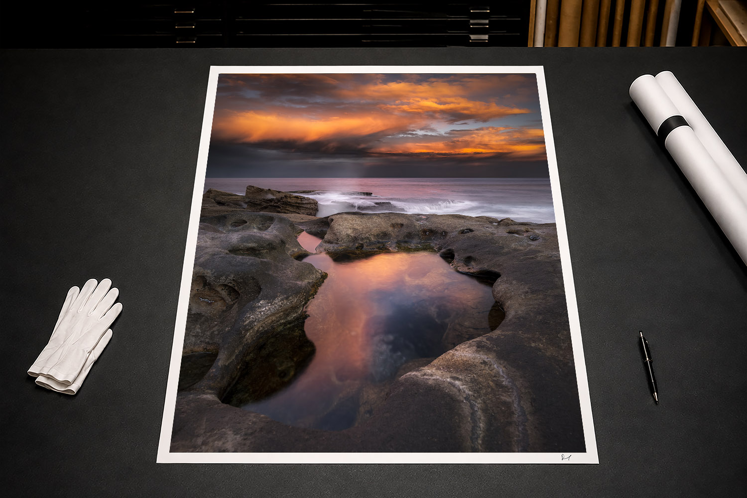 Fine art print of a reflective rock pool and dramatic orange sunset clouds at Bondi, Sydney, Australia.