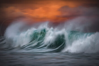 Turquoise ocean waves beneath a dramatic red sunset sky in Sydney, Australia, in fine art seascape photography