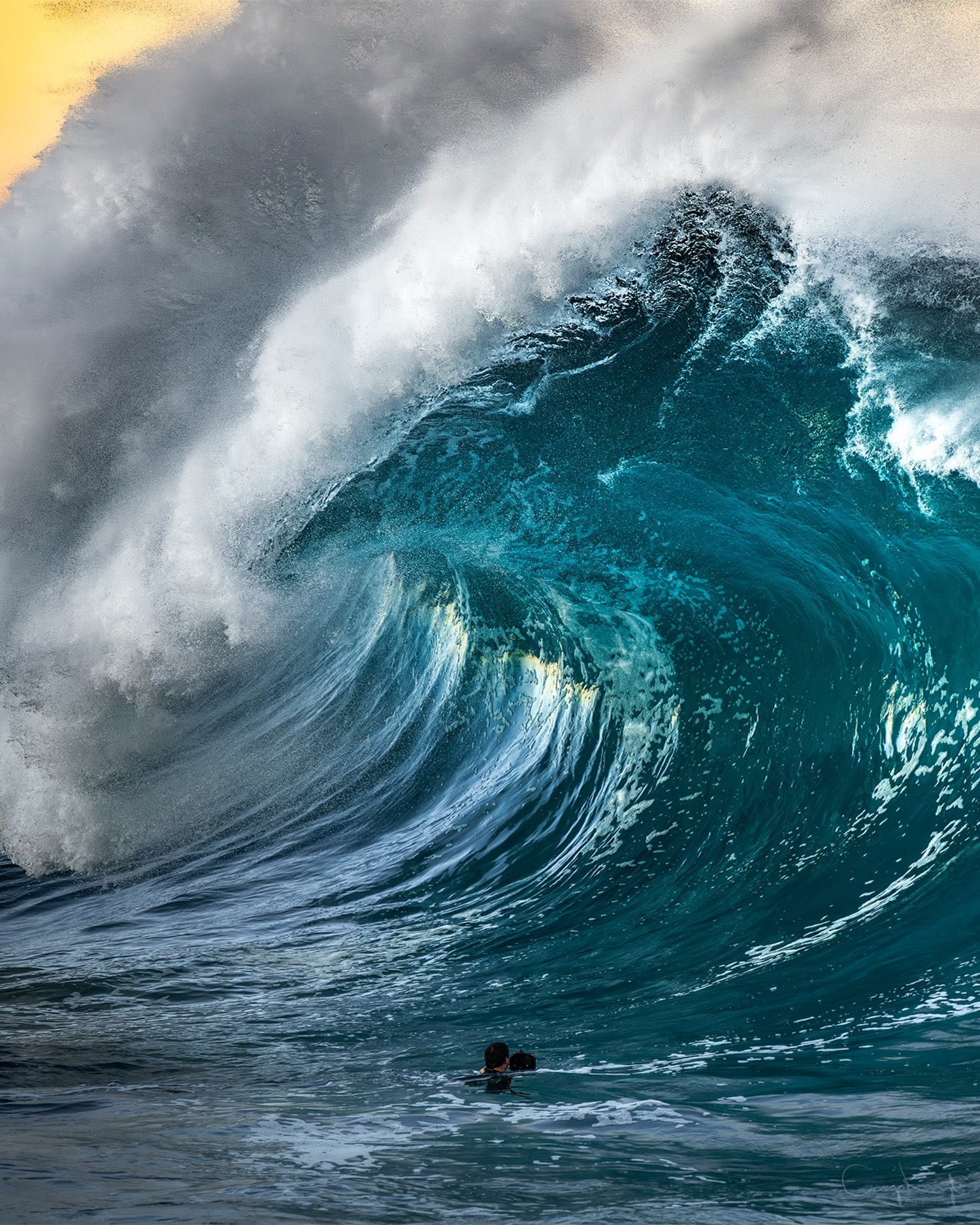 Judging by the photographer below, this wave stood nearly two storeys high, carrying hundreds of tonnes of seawater as it rose from the ocean. For a fraction of a second, wind, swell and light shaped this moving mountain into something that looked almost alive before it collapsed back into the sea.