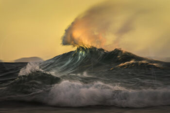 Ocean wave glowing in golden sunrise light at Byron Bay, Australia, captured as abstract fine art seascape photography
