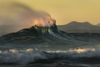 Ocean wave glowing in golden sunrise light at Byron Bay, Australia, captured as fine art seascape photography