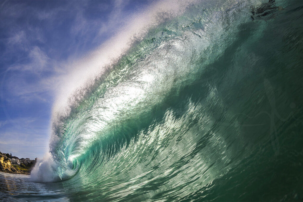 Powerful turquoise ocean wave breaking in the morning light at Tamarama Beach, Sydney, Australia, captured from the water