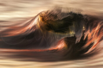 Breaking ocean wave glowing with warm sunset light in Sydney, Australia, captured as fine art seascape photography