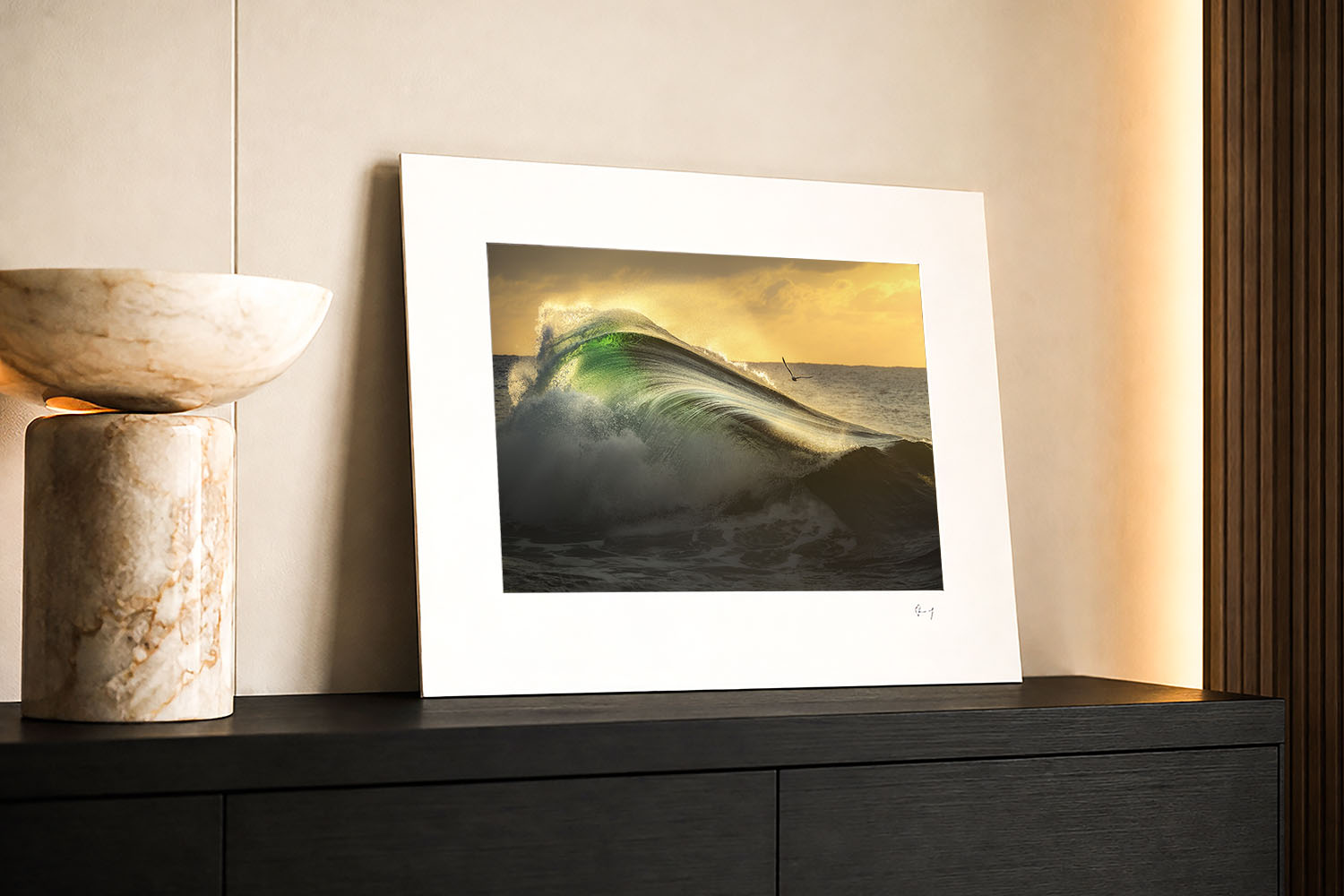 Mounted fine art print of an emerald sunrise wave in southern NSW, displayed as coastal wall art in a modern interior.