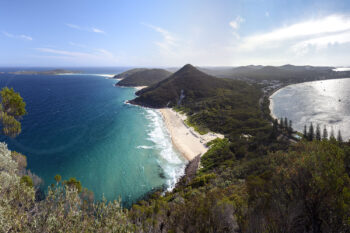 Panoramic coastal view from Mount Tomaree overlooking Zenith Beach and Shoal Bay, Port Stephens, NSW, Australia.