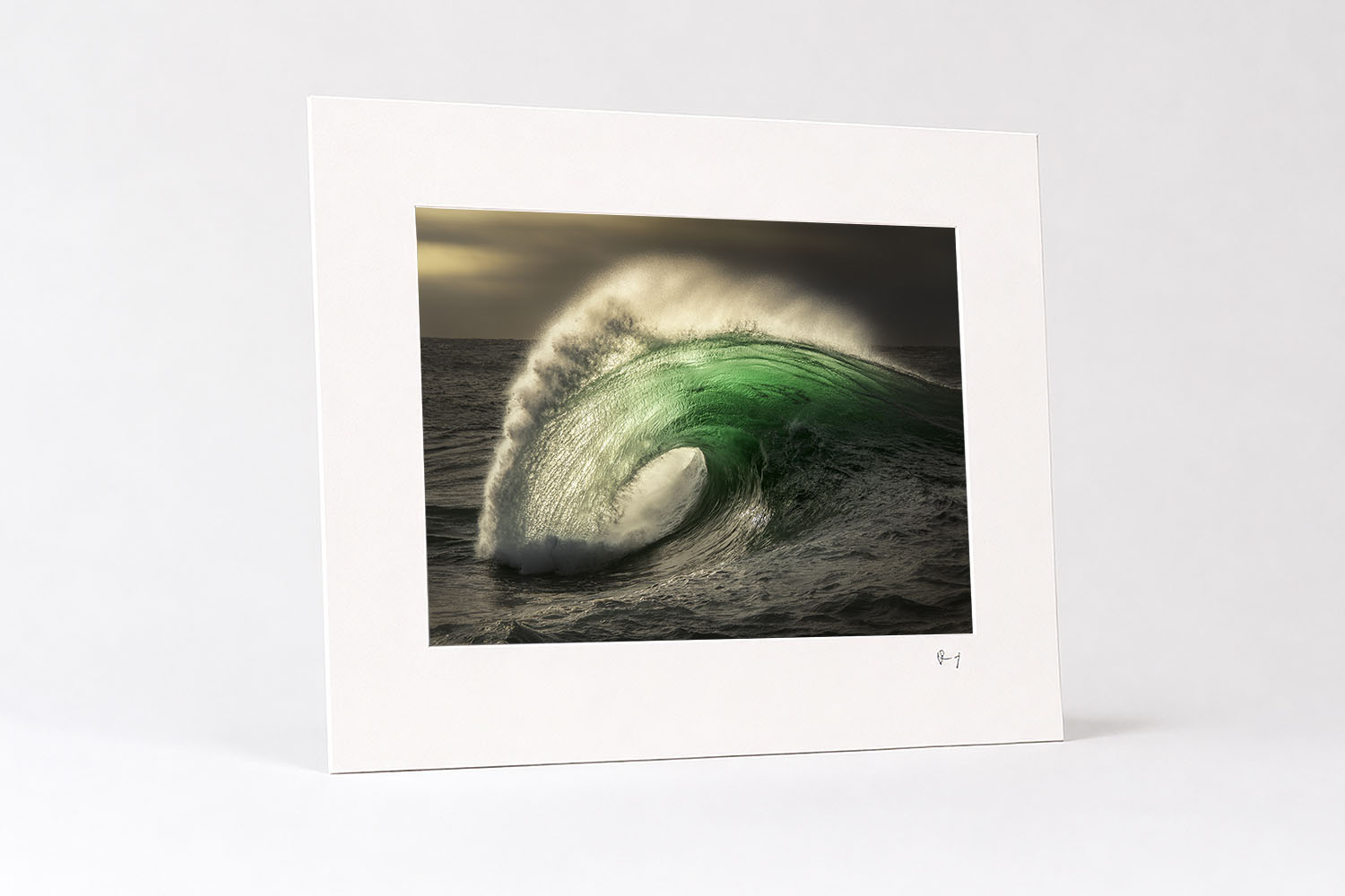 Mounted fine art print of a dramatic emerald wave glowing at sunrise in southern NSW, showcasing Australian ocean photography.