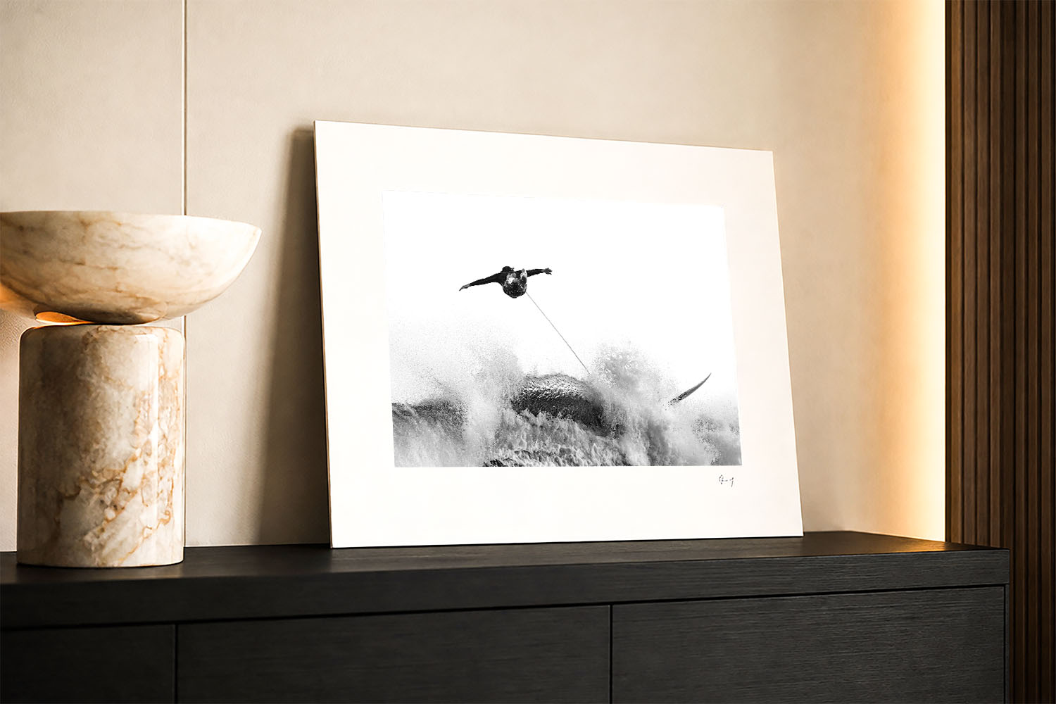 Mounted fine art print of a Tamarama Beach surfer wipeout displayed as black and white coastal wall art in a modern interior.