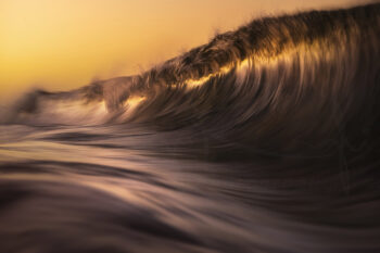 Golden ocean wave at sunset in Byron Bay, Australia, captured with motion blur in fine art seascape photography
