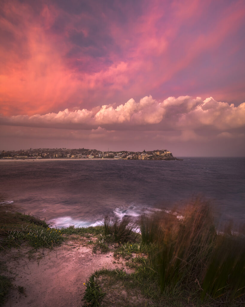 Arcus – Shelf cloud storm over Bronte Beach with dramatic skies, glowing sunset colours, and wild coastal weather in Sydney
