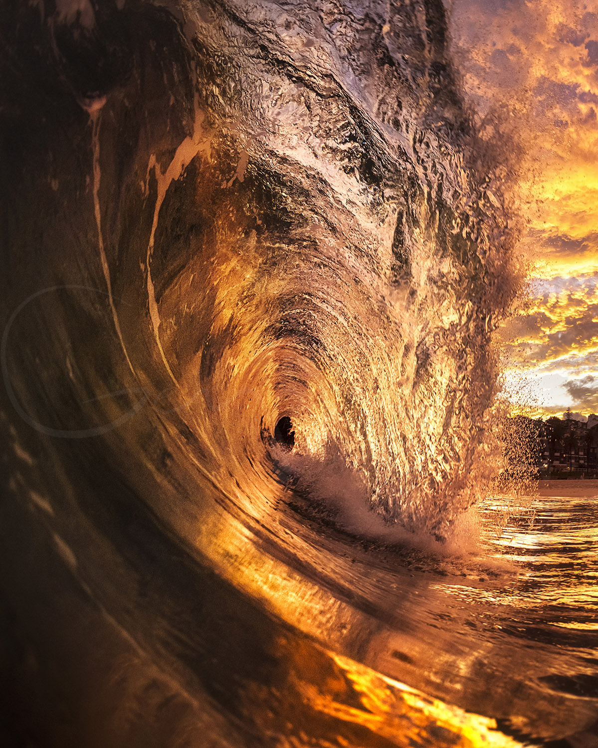 Powerful ocean wave glowing with sunset light at Bronte Beach, Sydney, Australia, captured from inside the breaking barrel