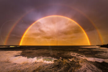 Stormy sunset with a dramatic double rainbow over Coogee Beach, Sydney, Australia, captured as fine art coastal photography.