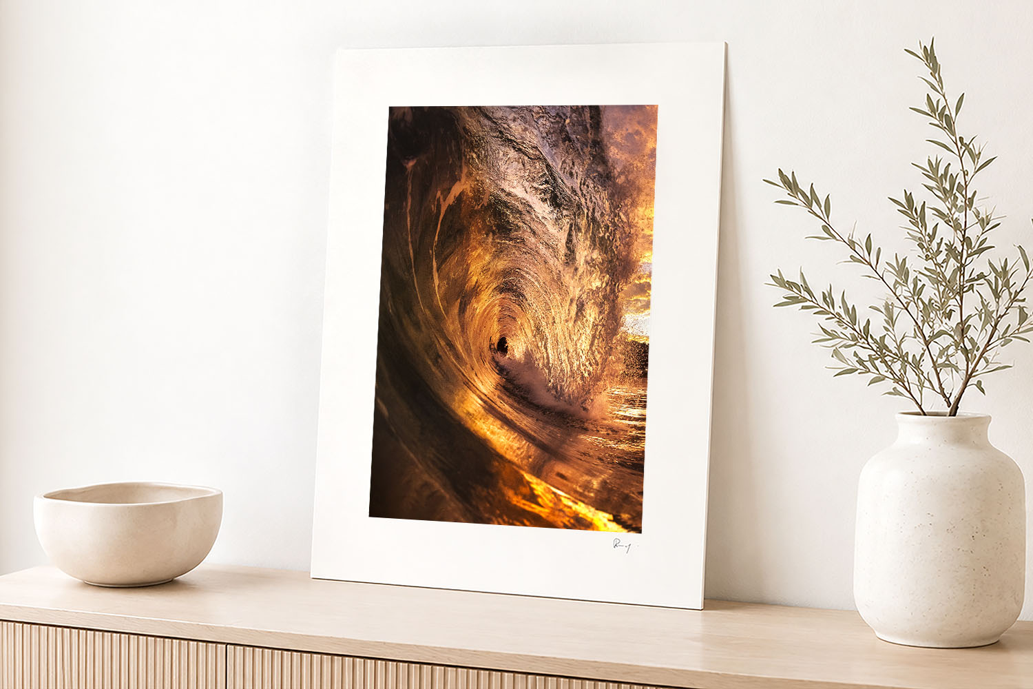 Mounted fine art photograph of a golden sunrise wave at Bronte Beach, displayed in a bright contemporary coastal interior.