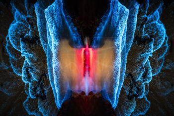 Abstract bioluminescent waves glowing electric blue and red at Jervis Bay, NSW, creating a striking symmetrical fine art photograph.