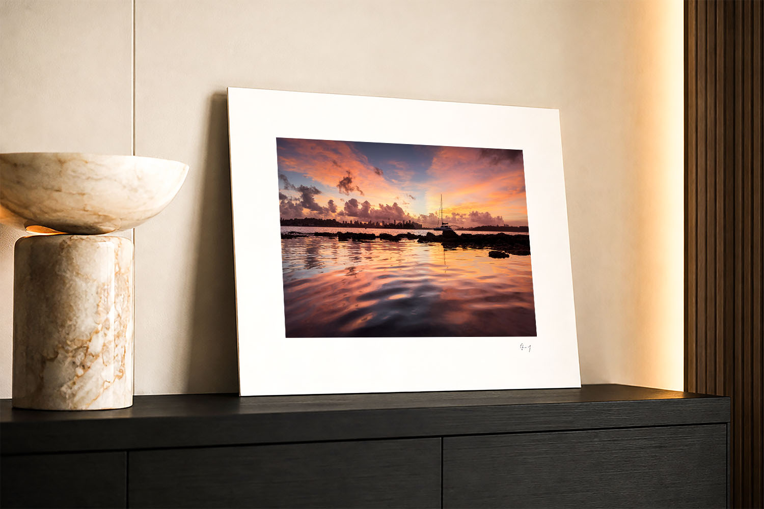 Mounted fine art photograph of a vibrant Milk Beach sunset, with vivid pink clouds, a sailboat and colourful harbour reflections.