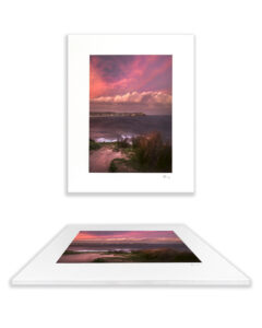 Dramatic pink storm clouds rolling over Bondi Beach at sunset, with windswept coastal grasses in the foreground – “Pink Storm” fine art print handmade in Australia.