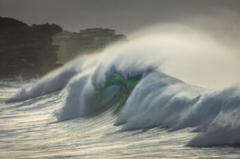 Award-winning fine art ocean photography of waves crashing at sunrise at Bronte Beach, Sydney, Australia, illuminated by golden light.