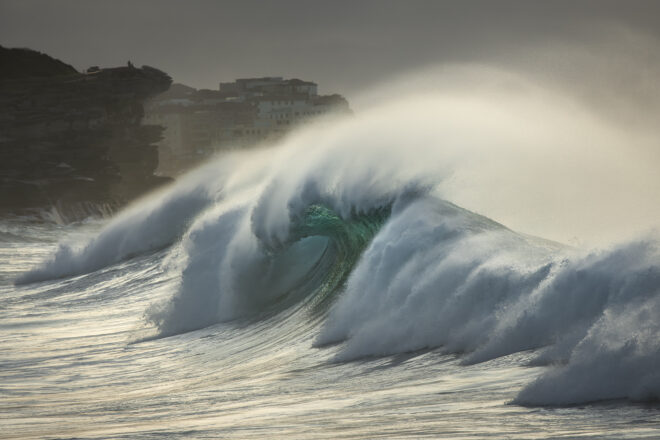 Award-winning fine art ocean photography of waves crashing at sunrise at Bronte Beach, Sydney, Australia, illuminated by golden light.
