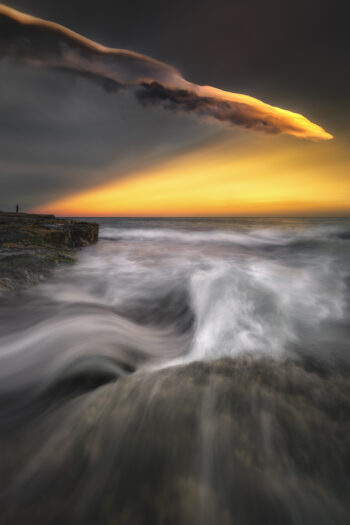 Mounted fine art print of an extraordinary storm sunset with towering illuminated clouds over Tamarama Beach, Sydney, Australia.