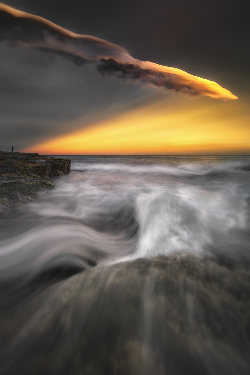 Mounted fine art print of an extraordinary storm sunset with towering illuminated clouds over Tamarama Beach, Sydney, Australia.