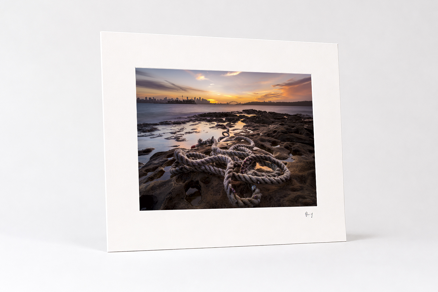 Mounted fine art photography print of a Milk Beach sunset overlooking Sydney Harbour, presented on white mat board.