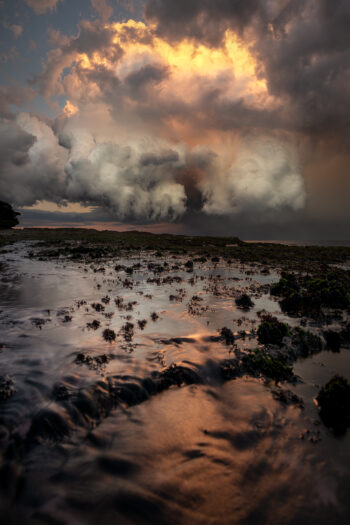 Mounted fine art print of a dramatic storm sunset over Tamarama Beach, Sydney, Australia, presented with a white mat board.